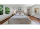 Spacious main bedroom with hardwood floors, white walls, and contemporary furnishings at 2298 Pembrook Pl, Atlanta, GA 30324