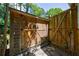 Backyard showing wooden storage shed with double doors and a fenced area on a stone path at 2298 Pembrook Pl, Atlanta, GA 30324