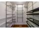 Walk-in closet with chrome shelving and dark wood flooring at 2298 Pembrook Pl, Atlanta, GA 30324