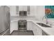 Well-lit kitchen features stainless steel appliances, white cabinetry, and marble countertops and backsplash at 2499 Peachtree Ne Rd # 503, Atlanta, GA 30305