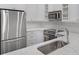 Modern kitchen with stainless steel appliances, white cabinets, marble countertops and a sink at 2499 Peachtree Ne Rd # 503, Atlanta, GA 30305