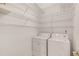 Well-lit laundry room featuring a washer, dryer, and shelving at 2499 Peachtree Ne Rd # 503, Atlanta, GA 30305