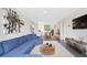 Bright living room featuring a comfortable blue sectional, art, and an open dining area, perfect for modern living at 2499 Peachtree Ne Rd # 503, Atlanta, GA 30305