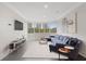 Elegant living room showcasing a blue sectional, city views through large windows, and contemporary decor for comfortable living at 2499 Peachtree Ne Rd # 503, Atlanta, GA 30305