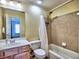 Bathroom featuring a tub/shower with tile surround, vanity with sink, and a separate area visible through open door at 475 Vinings Estates Se Dr # A03, Smyrna, GA 30126