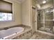 Well-lit bathroom features a soaking tub and a glass-enclosed shower for a spa-like experience at 475 Vinings Estates Se Dr # A03, Smyrna, GA 30126