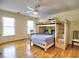 ' bedroom with a bunk bed, hardwood floors, ceiling fan, and natural light from multiple windows at 475 Vinings Estates Se Dr # A03, Smyrna, GA 30126