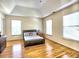 Bright bedroom with hardwood floors, tray ceiling, and lots of natural light from several windows at 475 Vinings Estates Se Dr # A03, Smyrna, GA 30126