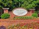 Elegant brick community sign with beautiful flowers and landscaping welcoming residents and visitors at 475 Vinings Estates Se Dr # A03, Smyrna, GA 30126