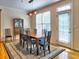 Traditional dining room with a wooden table, cushioned chairs, and an antique china cabinet near natural light from windows at 475 Vinings Estates Se Dr # A03, Smyrna, GA 30126