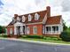 Beautiful brick building featuring dormer windows, a covered porch, and well-maintained landscaping at 475 Vinings Estates Se Dr # A03, Smyrna, GA 30126