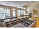 Open concept kitchen with breakfast bar, dining area and fireplace in the background at 475 Vinings Estates Se Dr # A03, Smyrna, GA 30126