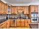 Well-equipped kitchen with wood cabinets, granite countertops, and stainless steel appliances at 475 Vinings Estates Se Dr # A03, Smyrna, GA 30126