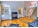 Spacious living room showcasing a cozy fireplace, built-in cabinets, and hardwood flooring at 475 Vinings Estates Se Dr # A03, Smyrna, GA 30126