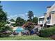 Community pool area featuring a slide, lounge seating, surrounded by lush landscaping, great for relaxation at 475 Vinings Estates Se Dr # A03, Smyrna, GA 30126