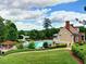 Community pool and recreation area with a slide, seating, and meticulously maintained landscaping and clubhouse at 475 Vinings Estates Se Dr # A03, Smyrna, GA 30126