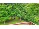 Beautiful backyard featuring mature trees and well-maintained lawn, viewed from the deck at 845 Stratford Rd, Avondale Estates, GA 30002