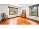 Spacious bedroom with hardwood floors and large windows offering ample natural light and a classic chair at 845 Stratford Rd, Avondale Estates, GA 30002