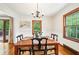 Comfortable dining area boasts hardwood floors, natural light, and deck access through sliding glass doors at 845 Stratford Rd, Avondale Estates, GA 30002