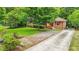 Charming brick home with well-maintained lawn, mature trees, and long driveway at 845 Stratford Rd, Avondale Estates, GA 30002