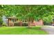 Beautiful brick home with manicured lawn, mature trees, and classic shutters at 845 Stratford Rd, Avondale Estates, GA 30002