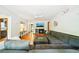Bright living room offers hardwood floors, a modern ceiling fan, and a cozy gray sectional sofa with throw pillows at 845 Stratford Rd, Avondale Estates, GA 30002