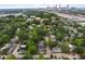 An aerial view showcasing the neighborhood with mature trees and the city skyline in the background at 1063 Manigault Se St, Atlanta, GA 30316