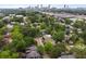 A charming neighborhood aerial view, full of mature trees with the Atlanta skyline in the background at 1063 Manigault Se St, Atlanta, GA 30316