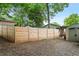 Fenced backyard with gravel, shed, and additional space for outdoor activities and storage at 1063 Manigault Se St, Atlanta, GA 30316