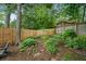 Landscaped backyard with a wooden fence and mature trees at 1063 Manigault Se St, Atlanta, GA 30316