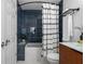 Stylish bathroom features blue subway tile, shower-tub combo, and modern fixtures at 1063 Manigault Se St, Atlanta, GA 30316