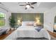 Spacious bedroom featuring a ceiling fan, hardwood floors, and natural light from a large window at 1063 Manigault Se St, Atlanta, GA 30316