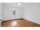 Bright bedroom with hardwood floors, white trim, and a window for natural light at 1063 Manigault Se St, Atlanta, GA 30316