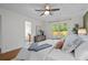 Bright bedroom featuring a ceiling fan, hardwood floors, and natural light from a large window at 1063 Manigault Se St, Atlanta, GA 30316