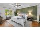 Spacious bedroom featuring a ceiling fan, hardwood floors, and natural light from a large window at 1063 Manigault Se St, Atlanta, GA 30316