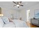 Bright bedroom with hardwood floors, ceiling fan, ensuite bathroom, and a neutral color palette at 1063 Manigault Se St, Atlanta, GA 30316