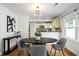 Eat-in dining area with decorative light fixture, adjacent to kitchen, hardwood floors and natural light at 1063 Manigault Se St, Atlanta, GA 30316