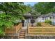 Attractive bungalow showcases a quaint front porch, lovely landscape design, and delightful wooden fencing at 1063 Manigault Se St, Atlanta, GA 30316