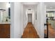 Long hallway with hardwood flooring leading to a kitchen and a bathroom at 1063 Manigault Se St, Atlanta, GA 30316