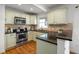 Well-lit kitchen with granite countertops and stainless steel appliances with hardwood flooring at 1063 Manigault Se St, Atlanta, GA 30316