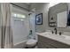 Bathroom shows tiled shower, white subway tile, window, toilet, and light gray vanity at 1892 Raven Hill Ne Dr, Atlanta, GA 30319
