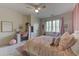 Charming bedroom with pink accents including a bed and desk setup at 1892 Raven Hill Ne Dr, Atlanta, GA 30319