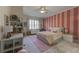 Charming bedroom with pink striped accent wall, plush carpet and window with views at 1892 Raven Hill Ne Dr, Atlanta, GA 30319