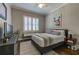 Bedroom features plantation shutters, ceiling fan, closet, and hardwood floors at 1892 Raven Hill Ne Dr, Atlanta, GA 30319