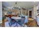 Open concept dining area next to kitchen and living room boasts stylish chandelier, table, and chairs at 1892 Raven Hill Ne Dr, Atlanta, GA 30319