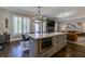 Modern kitchen island with seating and open concept to living room and fireplace at 1892 Raven Hill Ne Dr, Atlanta, GA 30319