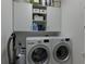 Efficient laundry room with stacked washer and dryer and convenient overhead shelving at 1892 Raven Hill Ne Dr, Atlanta, GA 30319