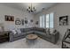 Living room featuring a gray sectional sofa, round wood table, and framed wall art at 1892 Raven Hill Ne Dr, Atlanta, GA 30319