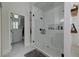 A glass enclosed shower with subway tile, and view into the toilet and linen closet at 1892 Raven Hill Ne Dr, Atlanta, GA 30319