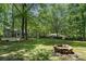 Spacious backyard with mature trees and partially fenced perimeter, great for outdoor enjoyment at 3262 Bluff Rd, Marietta, GA 30062